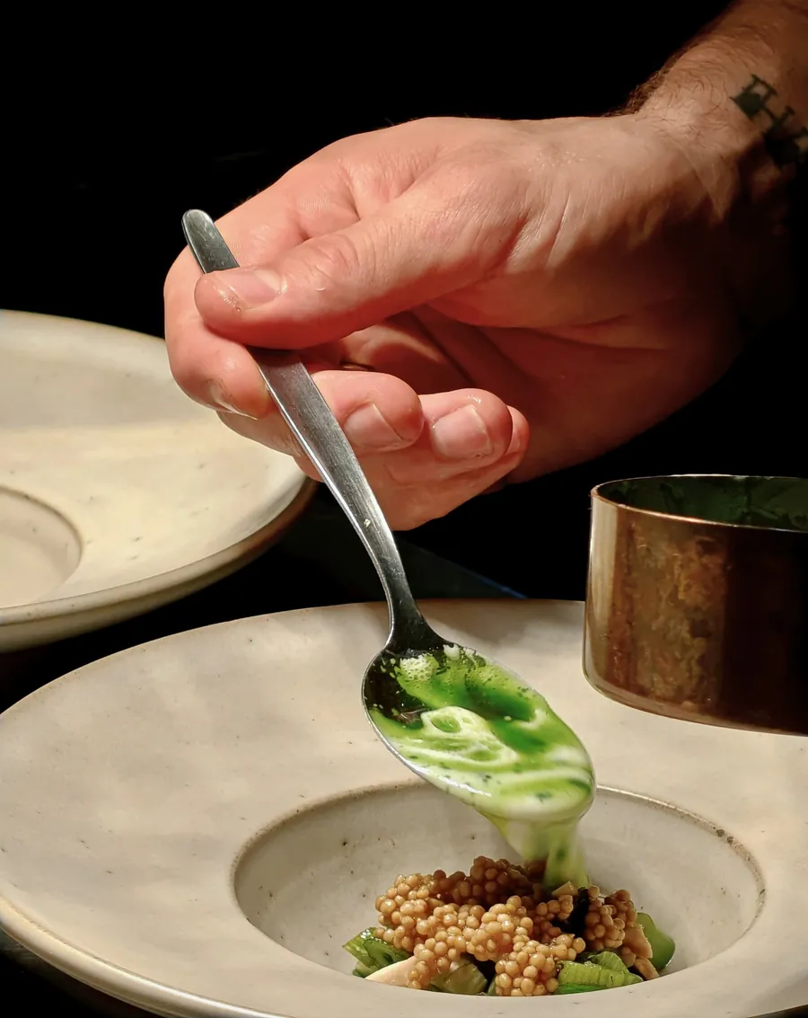 The chef plating dishes at the counter